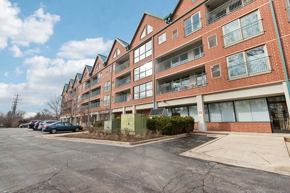 Front view of a multi-story brick building with multiple balconies.