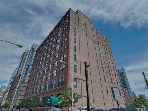 Front view of a multi-story building with red and brown brick facade.
