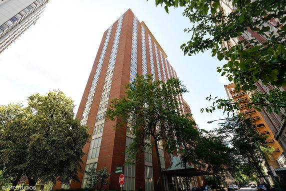 Front view of a tall brick building with multiple floors and windows