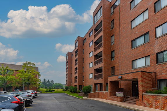 Front view of a multi-story brick building with balconies.