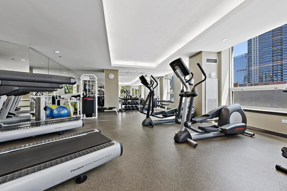 Indoor gym area with exercise machines and equipment.