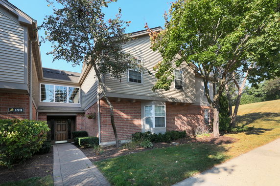 Front view of a two-story house with brick and siding exterior.