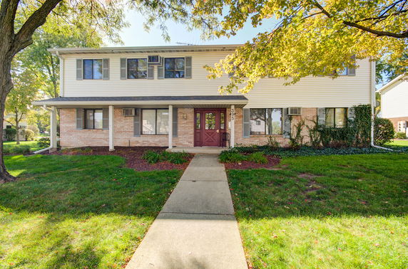 Front view of a two-story house with a walkway leading to the entrance.