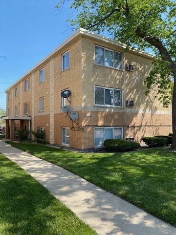 Front view of a three-story brick apartment building.