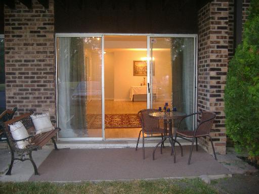 Front view of a house with a sliding glass door and brick walls.