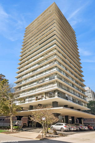 Front view of a tall multi-story building with balconies.