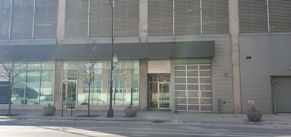 Front view of a building with large windows and glass door.
