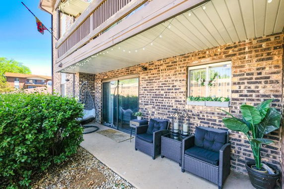 Front view of a brick building with a covered patio area.