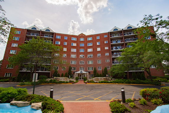 Front view of a multi-story brick building with balconies.
