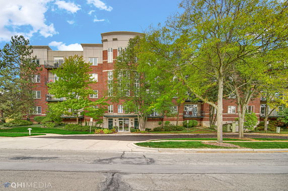 Front view of a multi-story building with a brick facade.