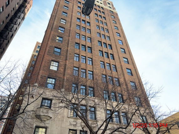 Front view of a multi-story brick building with numerous windows.