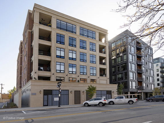Front view of a multi-story residential building with balconies.