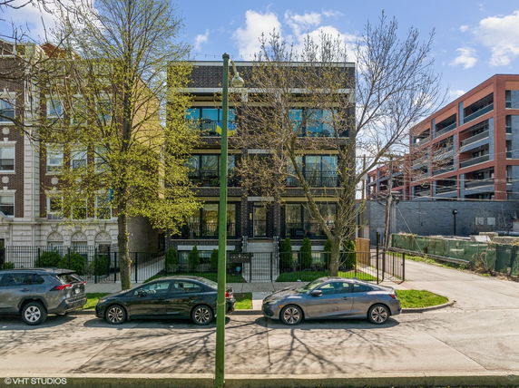 Front view of a modern multi-story apartment building.