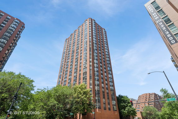 Front view of a tall high-rise building with multiple floors and large windows.
