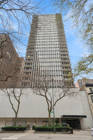Front view of a tall, multi-story building with balconies.