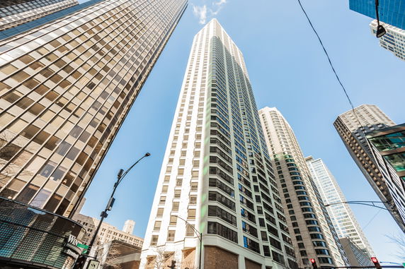 Upward view of a tall skyscraper with modern window design.