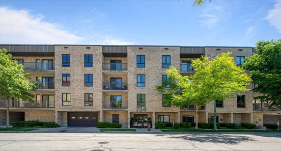Front view of a multi-story apartment building with balconies.
