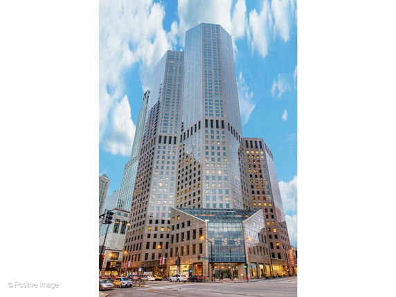 Front view of a tall skyscraper in a city setting.