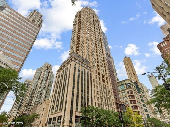 Front view of a tall skyscraper with a detailed façade.
