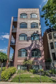 Front view of a multi-story brick apartment building.