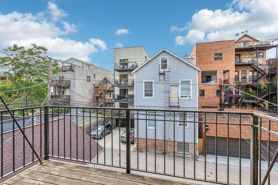 View from a balcony overlooking multiple residential buildings.