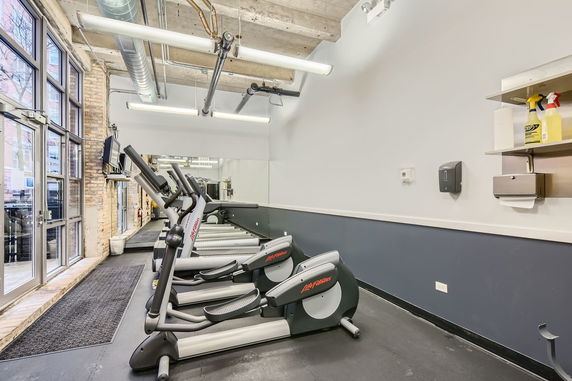 Interior of a gym area with treadmills and exercise equipment.