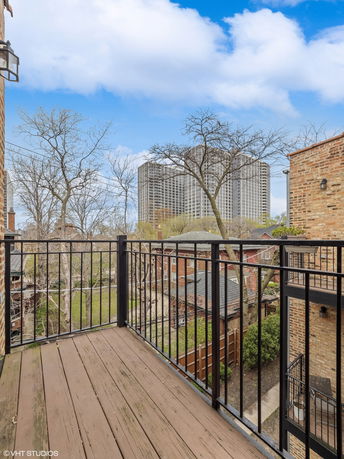 View of a balcony overlooking residential and high-rise buildings.