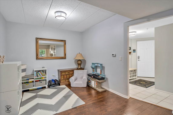 Indoor children's play area with toys and shelving.
