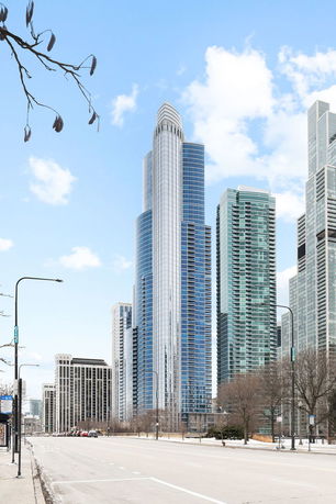 Front view of a modern high-rise skyscraper with glass facade.