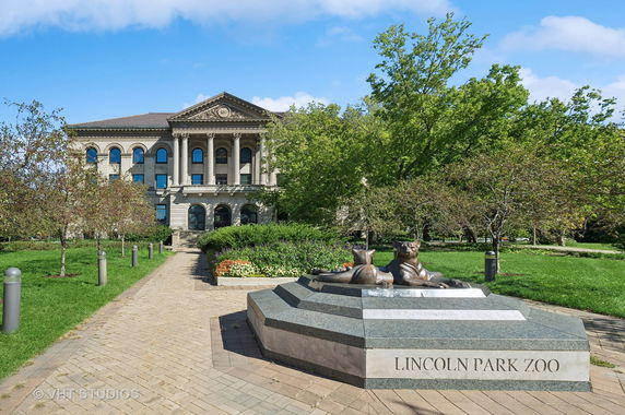 Front view of a historic building with columns and stone facade.