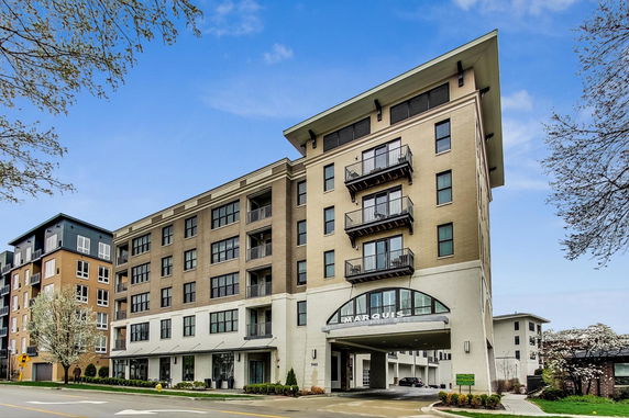 Front view of a multi-story apartment building with balconies.