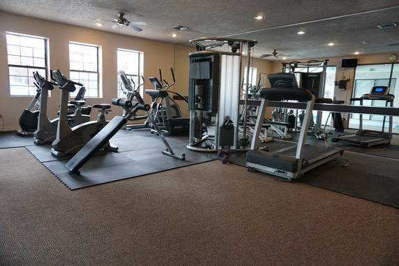 Room equipped with exercise machines and gym equipment.