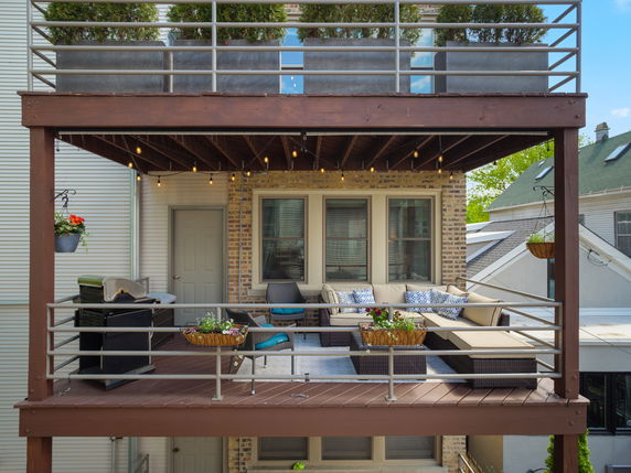 View of a balcony with outdoor seating.