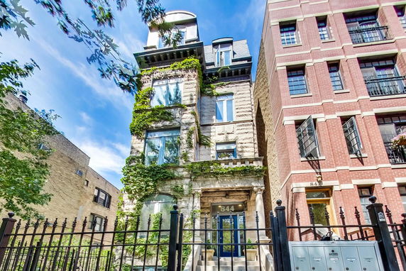 Front view of a multi-story building with ivy-covered stone facade.