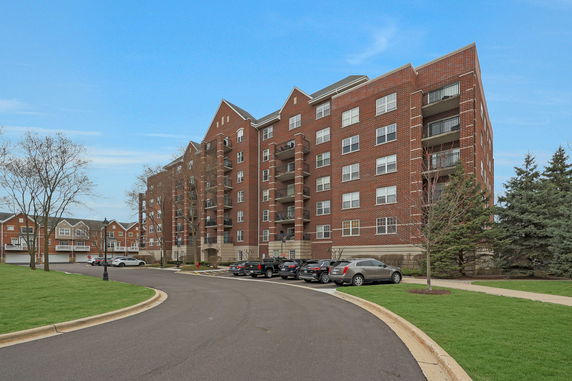Front view of a multi-story brick apartment building.