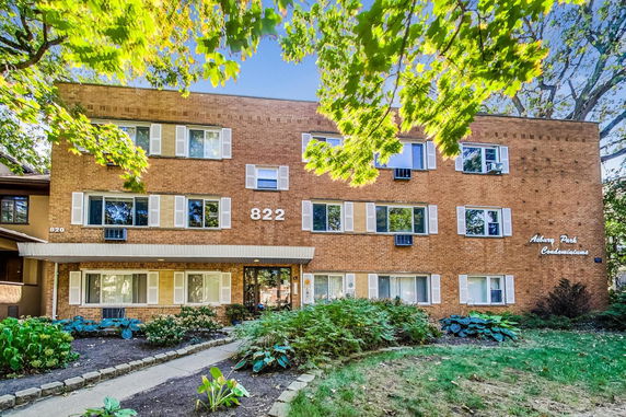 Front view of a three-story brick condominium building.