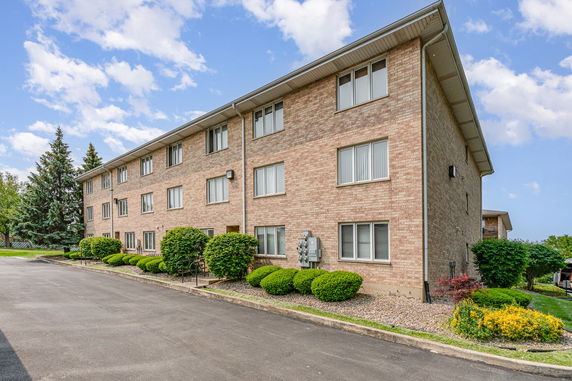 Elevated view of a multi-story brick apartment building.