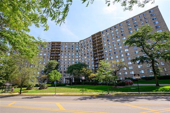 Front view of a large multi-story apartment building.