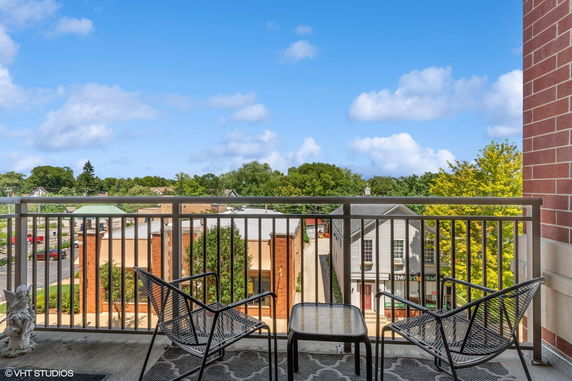View from a balcony overlooking surrounding buildings and greenery
