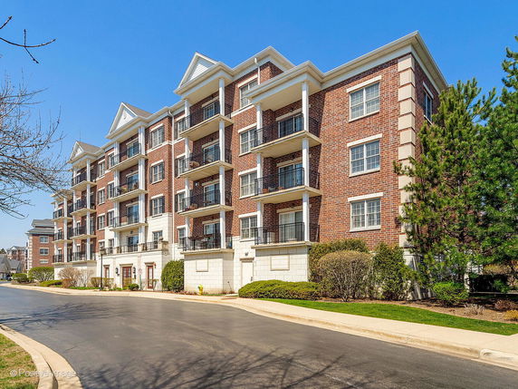 Front view of a multi-story brick apartment building.