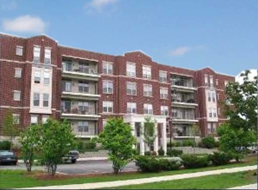 Front view of a multi-story apartment building with balconies.