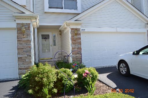 Front view of a house with a double garage and stone accents.