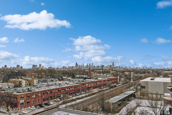 Panoramic view of cityscape with buildings and skyline in the background under a clear blue sky.
