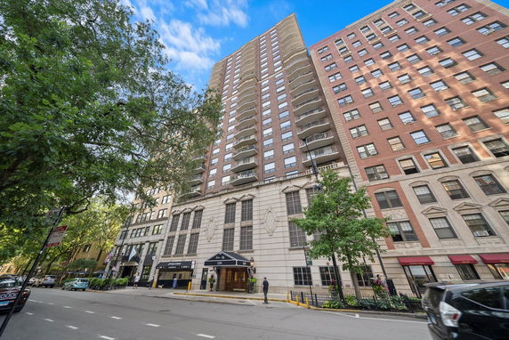 Front view of a tall residential building with balconies.