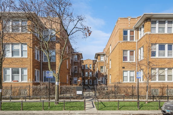 Front view of a multi-story brick apartment building.