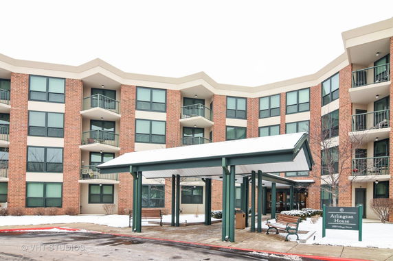 Front view of a multi-story apartment building with balconies.