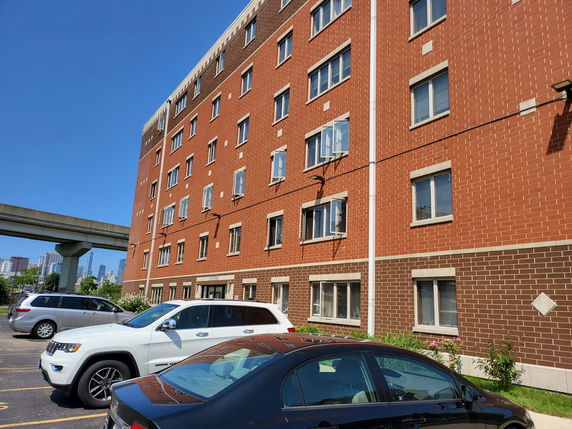 Front view of a multi-story brick apartment building