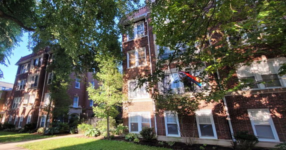 Front view of a multi-story brick apartment building.
