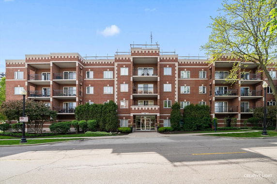 Front view of a multi-story brick apartment building.
