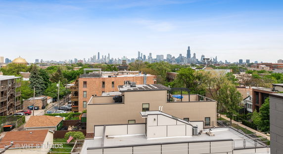 Panoramic view of city skyline from a rooftop.